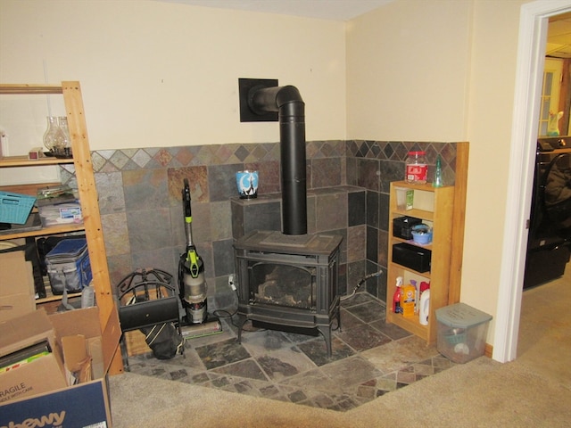 interior details featuring a wood stove and carpet floors