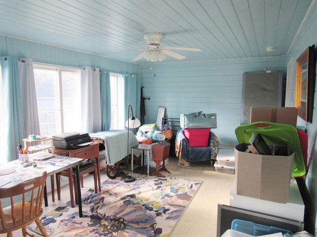 interior space featuring light colored carpet, ceiling fan, wooden ceiling, and wood walls