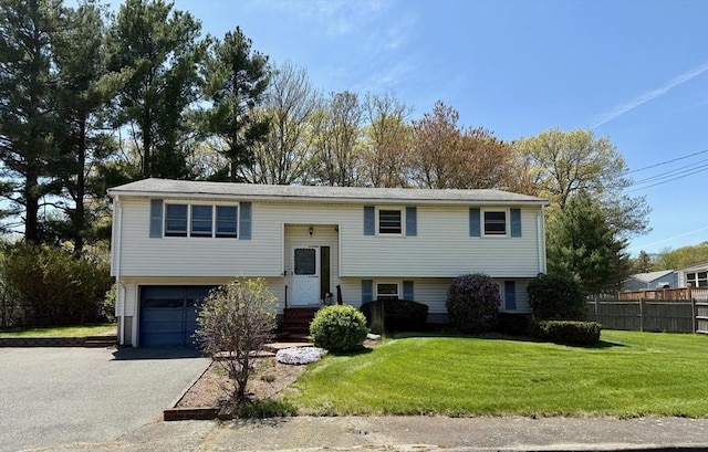 4 Fernandez Cir, Randolph, MA 02368 - split foyer home featuring an attached garage and driveway