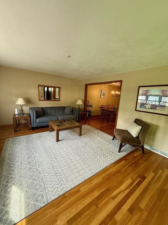 4 Fernandez Cir, Randolph, MA 02368 - living room featuring wood finished floors and a chandelier