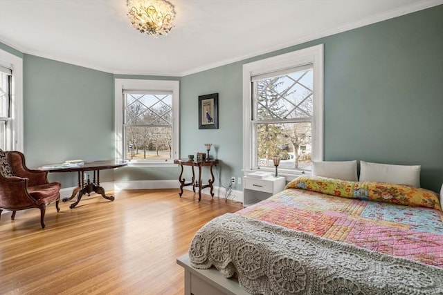 bedroom with crown molding and hardwood / wood-style flooring