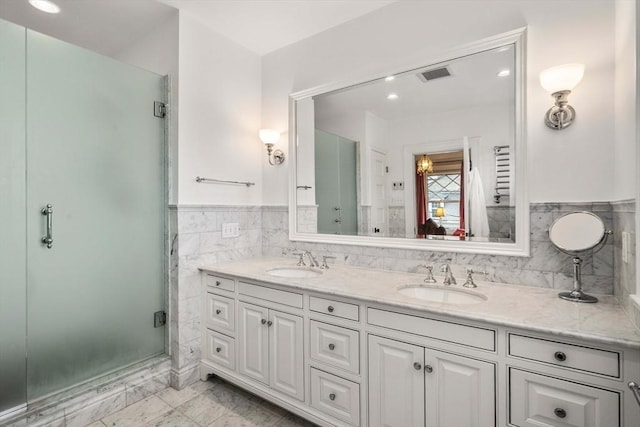 bathroom with vanity, tile walls, and walk in shower