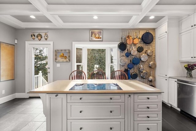 kitchen with dishwasher, a kitchen island, black electric stovetop, and white cabinets