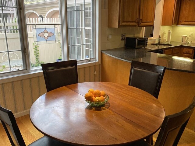 dining area with healthy amount of natural light and light wood-style floors