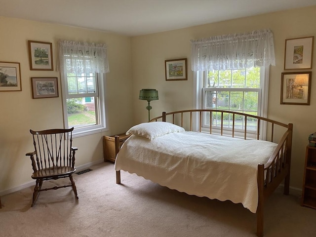 carpeted bedroom featuring baseboards