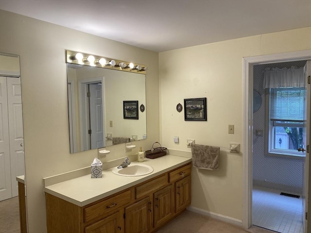 bathroom featuring vanity and baseboards