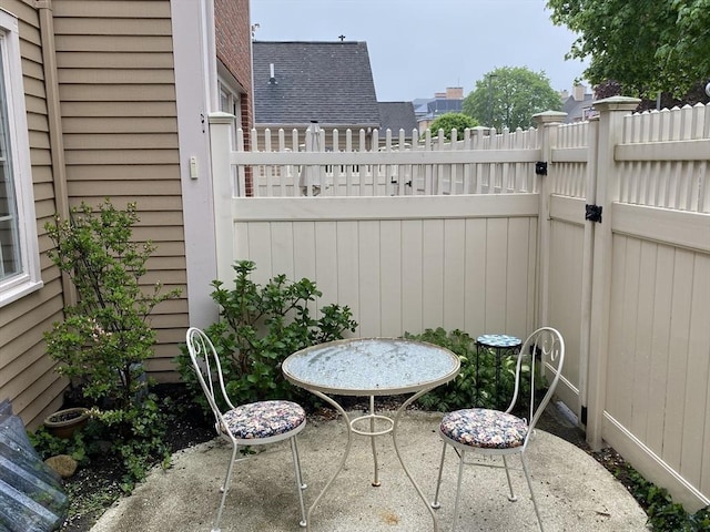 view of patio with fence and a gate