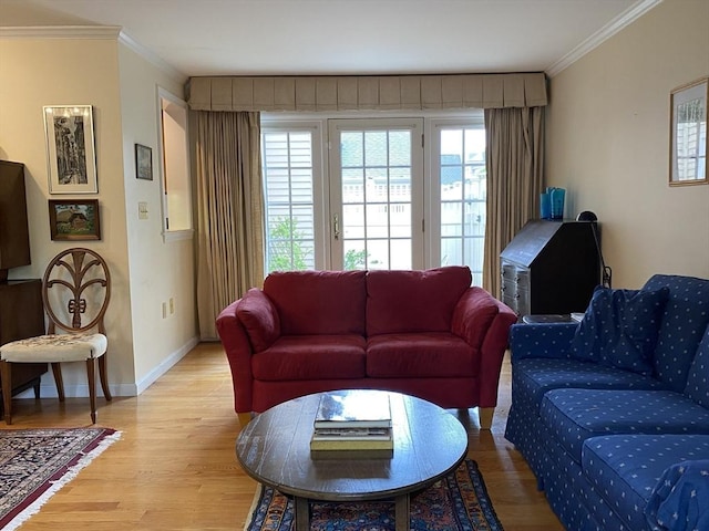 living room featuring baseboards, light wood-style floors, and ornamental molding