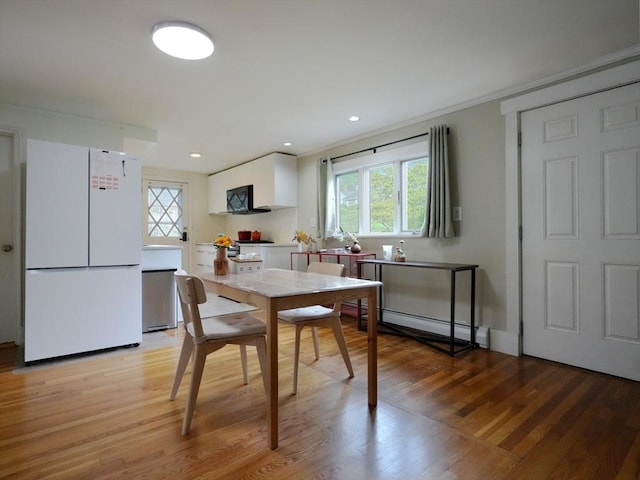 347 Lexington St, Woburn, MA 01801 - dining space with a baseboard radiator, light wood-style flooring, and recessed lighting
