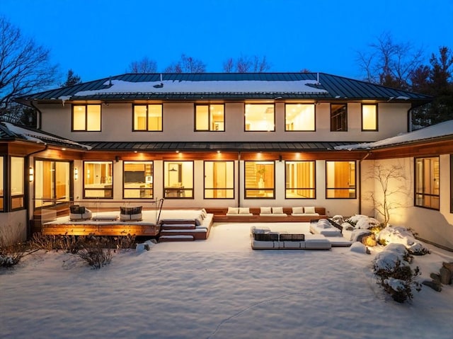 snow covered house featuring a patio