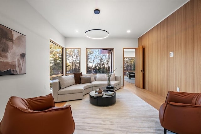 living room with wooden walls and light wood-type flooring