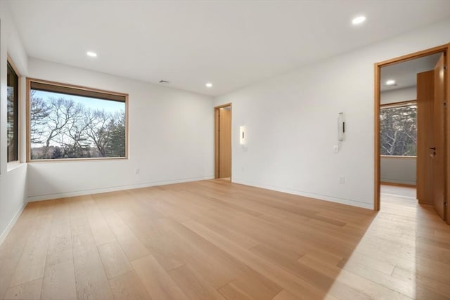 unfurnished room with light wood-type flooring