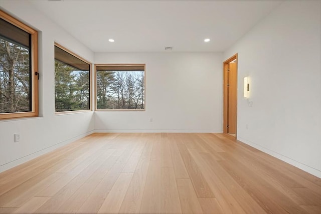 unfurnished room with light hardwood / wood-style flooring