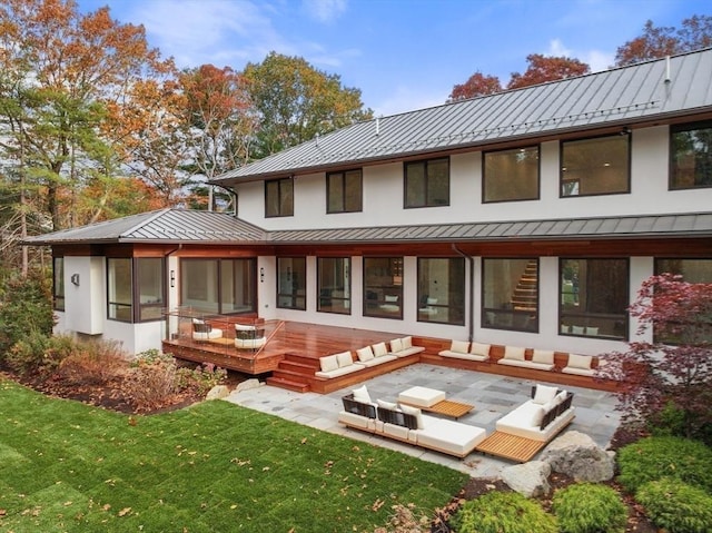 rear view of house with a yard, an outdoor hangout area, and a deck