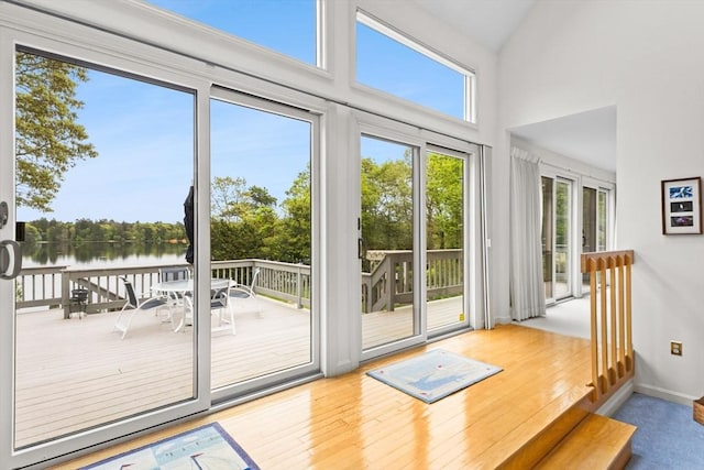 376 Flint St, Barnstable, MA 02648 - doorway to outside featuring a water view, healthy amount of natural light, wood finished floors, a high ceiling, and baseboards