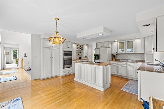 376 Flint St, Barnstable, MA 02648 - kitchen with double oven, white fridge with ice dispenser, light wood-style floors, electric cooktop, and a sink