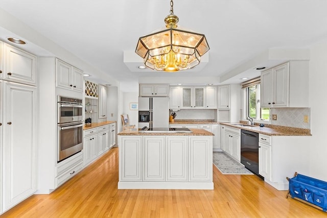 376 Flint St, Barnstable, MA 02648 - kitchen with black dishwasher, white refrigerator with ice dispenser, light wood-style floors, cooktop, and recessed lighting