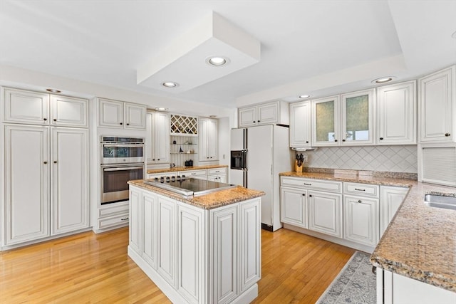 376 Flint St, Barnstable, MA 02648 - kitchen featuring black electric stovetop, white fridge with ice dispenser, double oven, decorative backsplash, and recessed lighting