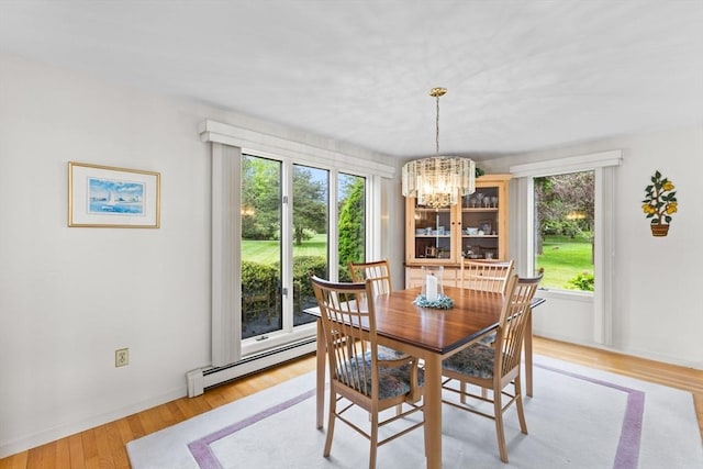 376 Flint St, Barnstable, MA 02648 - dining area with baseboard heating, a chandelier, light wood-type flooring, and baseboards