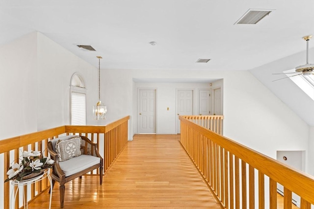376 Flint St, Barnstable, MA 02648 - hall with light wood-style flooring, an upstairs landing, and a chandelier