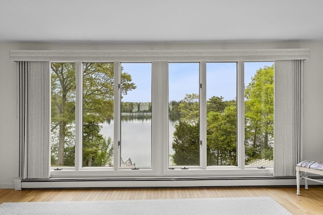 376 Flint St, Barnstable, MA 02648 - doorway featuring baseboard heating, a water view, and wood finished floors