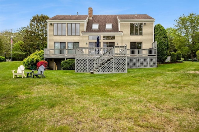 376 Flint St, Barnstable, MA 02648 - rear view of house featuring a deck, a lawn, a chimney, and a shingled roof