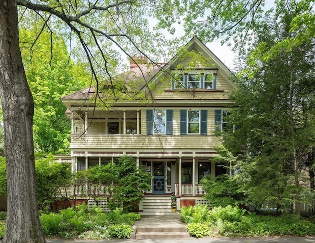 view of front of property featuring covered porch and a balcony