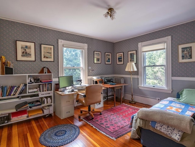 bedroom with hardwood / wood-style flooring, wallpapered walls, an office area, crown molding, and wainscoting