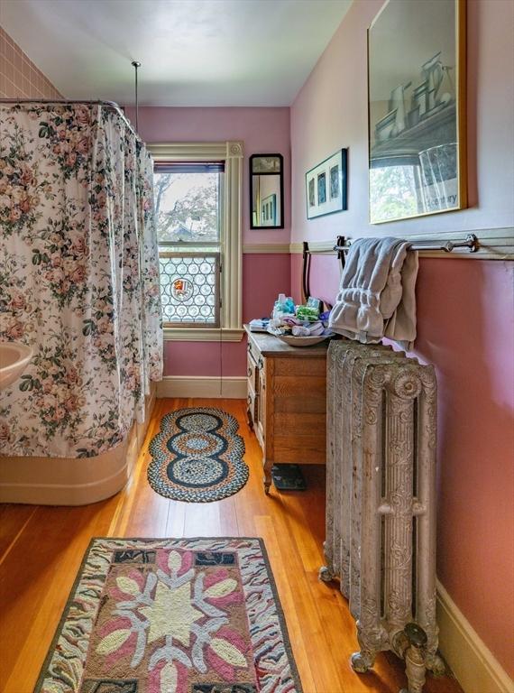 interior space featuring light wood-style flooring and baseboards