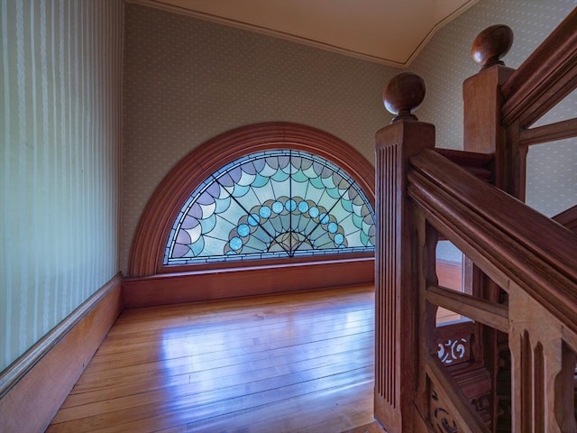 detailed view of wallpapered walls, wood finished floors, and ornamental molding
