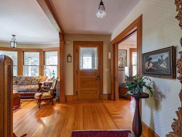 entryway with light wood-style flooring and wallpapered walls