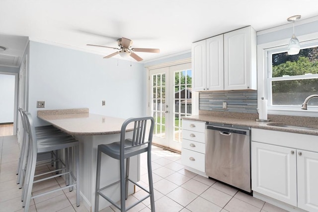 25 Watson St, Seekonk, MA 02771 - kitchen featuring stainless steel dishwasher, a sink, a kitchen bar, white cabinets, and backsplash