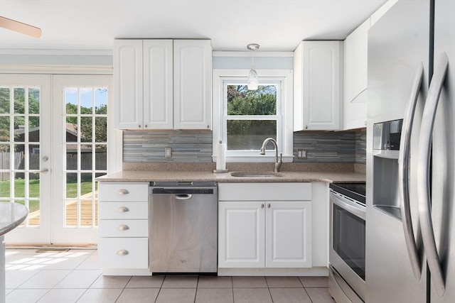25 Watson St, Seekonk, MA 02771 - kitchen featuring stainless steel appliances, a sink, light tile patterned flooring, french doors, and plenty of natural light