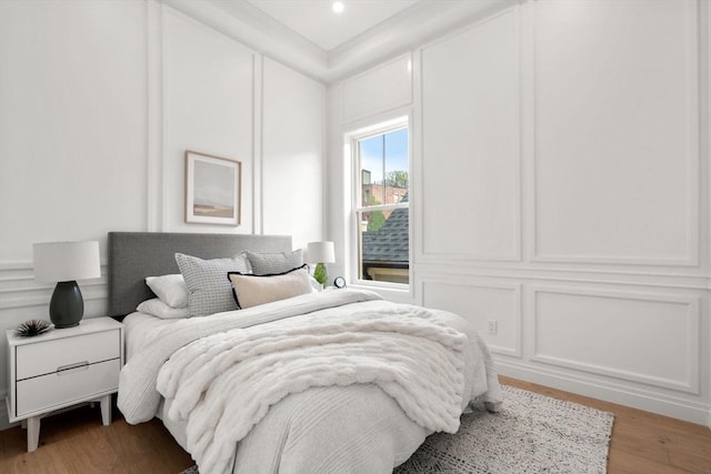 9 Russell Unit 2, Boston, MA 02129 - bedroom featuring light wood-type flooring and a decorative wall