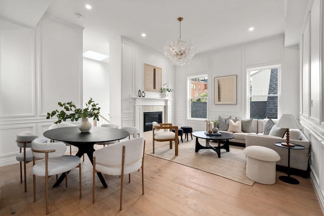 9 Russell Unit 2, Boston, MA 02129 - dining space featuring a decorative wall, a glass covered fireplace, light wood finished floors, a chandelier, and recessed lighting