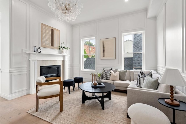 9 Russell Unit 2, Boston, MA 02129 - living room featuring a decorative wall, a glass covered fireplace, crown molding, light wood-type flooring, and a chandelier