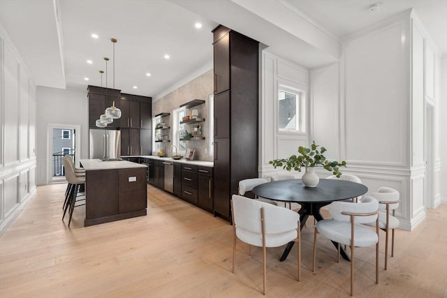 9 Russell Unit 2, Boston, MA 02129 - kitchen with a decorative wall, appliances with stainless steel finishes, a center island, open shelves, and light countertops