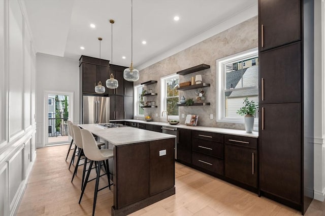 9 Russell Unit 2, Boston, MA 02129 - kitchen featuring stainless steel appliances, open shelves, a kitchen bar, a kitchen island, and plenty of natural light