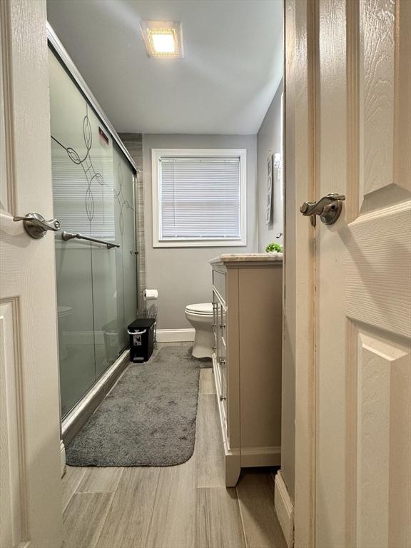 11 Marie Ave, Brockton, MA 02302 - full bath with wood finished floors, a stall shower, toilet, and baseboards