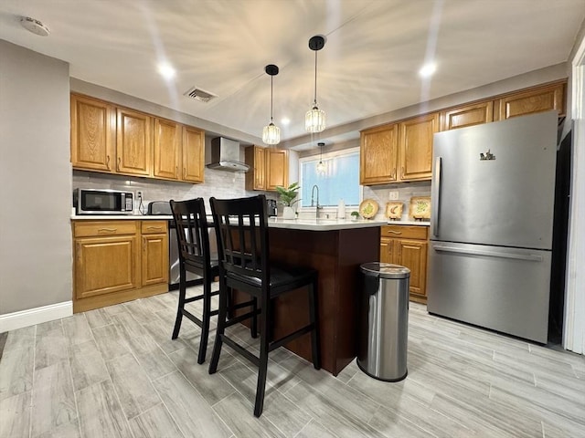 11 Marie Ave, Brockton, MA 02302 - kitchen with stainless steel appliances, wall chimney range hood, light countertops, decorative backsplash, and decorative light fixtures