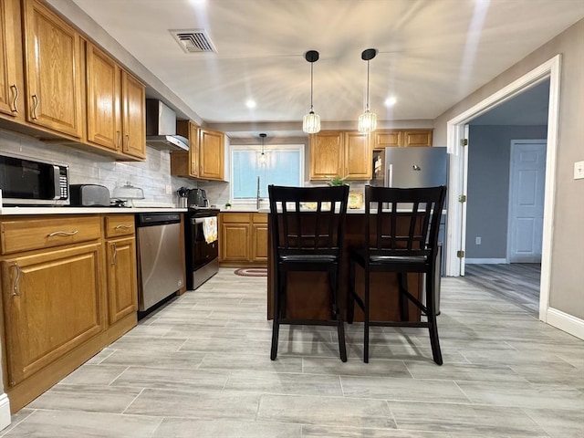 11 Marie Ave, Brockton, MA 02302 - kitchen featuring stainless steel appliances, wall chimney exhaust hood, brown cabinets, light countertops, and baseboards