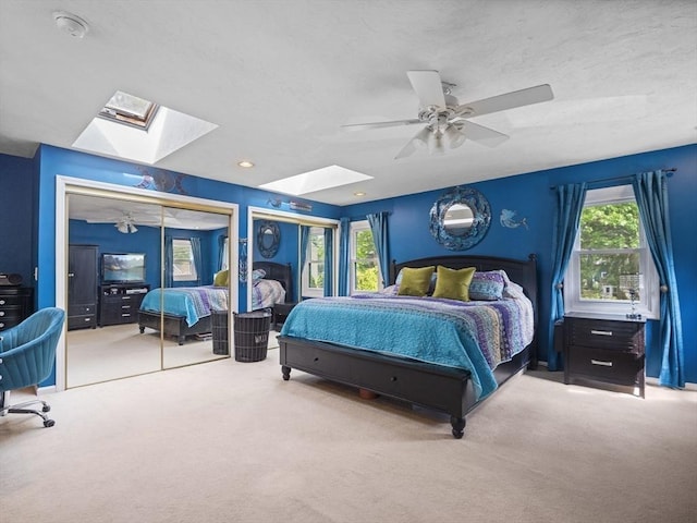 34 Lake Shore Dr S, Westford, MA 01886 - carpeted bedroom featuring a skylight and a ceiling fan