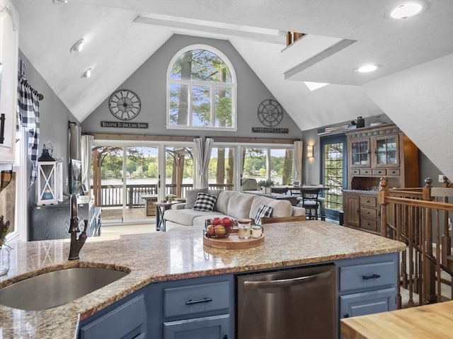 34 Lake Shore Dr S, Westford, MA 01886 - kitchen featuring dishwasher, blue cabinets, high vaulted ceiling, open floor plan, and light stone countertops