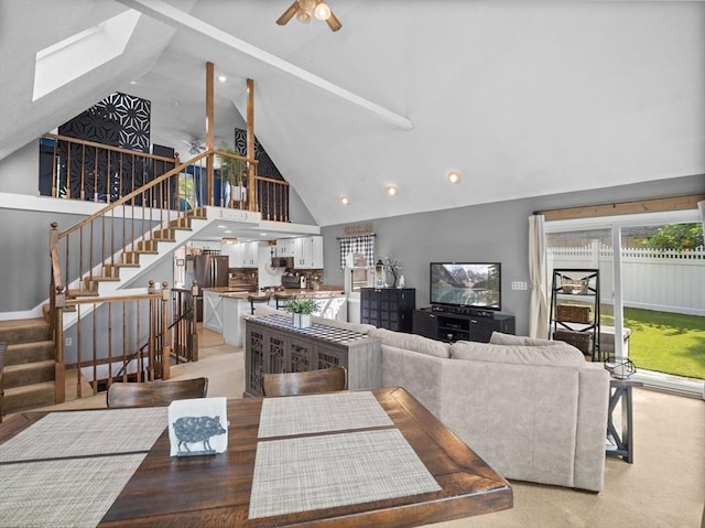 34 Lake Shore Dr S, Westford, MA 01886 - living area featuring high vaulted ceiling, ceiling fan, stairs, beamed ceiling, and a skylight