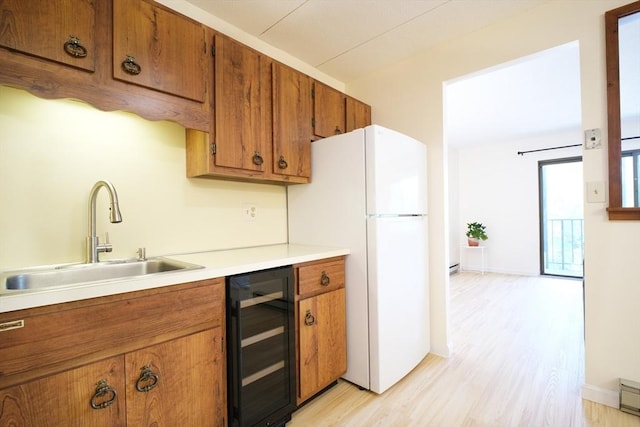 235 Winthrop St Unit 4407, Medford, MA 02155 - kitchen with beverage cooler, brown cabinets, freestanding refrigerator, and light wood-type flooring