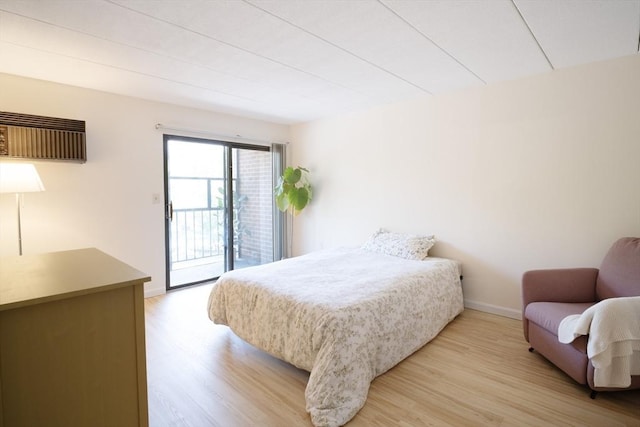 235 Winthrop St Unit 4407, Medford, MA 02155 - bedroom with access to exterior, light wood-style floors, and a wall unit AC