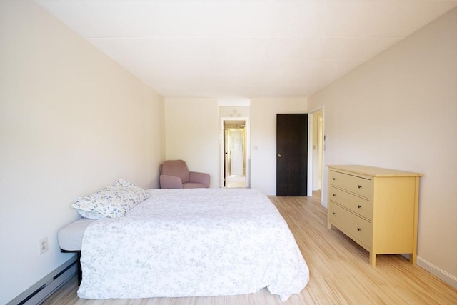 235 Winthrop St Unit 4407, Medford, MA 02155 - bedroom with a baseboard heating unit, light wood-type flooring, and ensuite bathroom