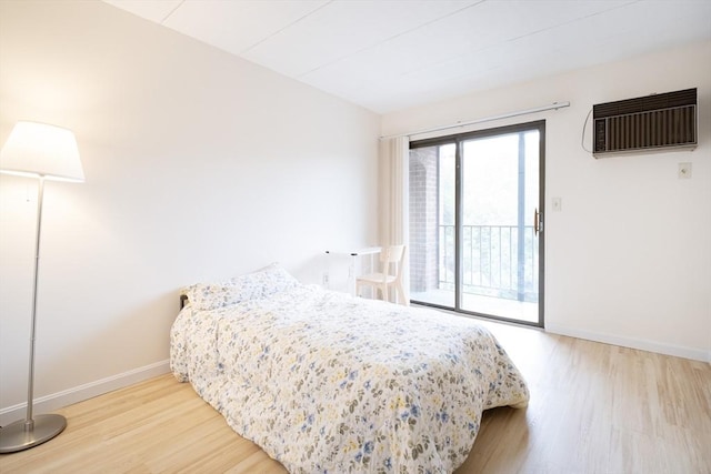 235 Winthrop St Unit 4407, Medford, MA 02155 - bedroom with access to outside, wood finished floors, and a wall mounted air conditioner