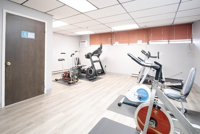 235 Winthrop St Unit 4407, Medford, MA 02155 - workout room featuring a paneled ceiling, wood finished floors, an AC wall unit, and a baseboard heating unit