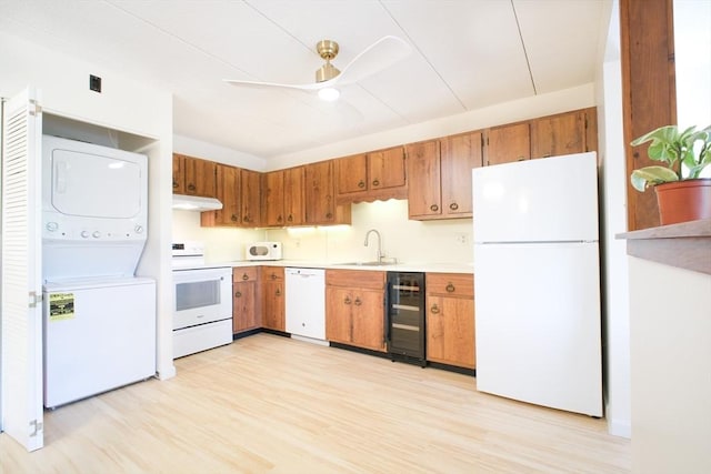 235 Winthrop St Unit 4407, Medford, MA 02155 - kitchen featuring white appliances, beverage cooler, stacked washer and clothes dryer, under cabinet range hood, and light countertops